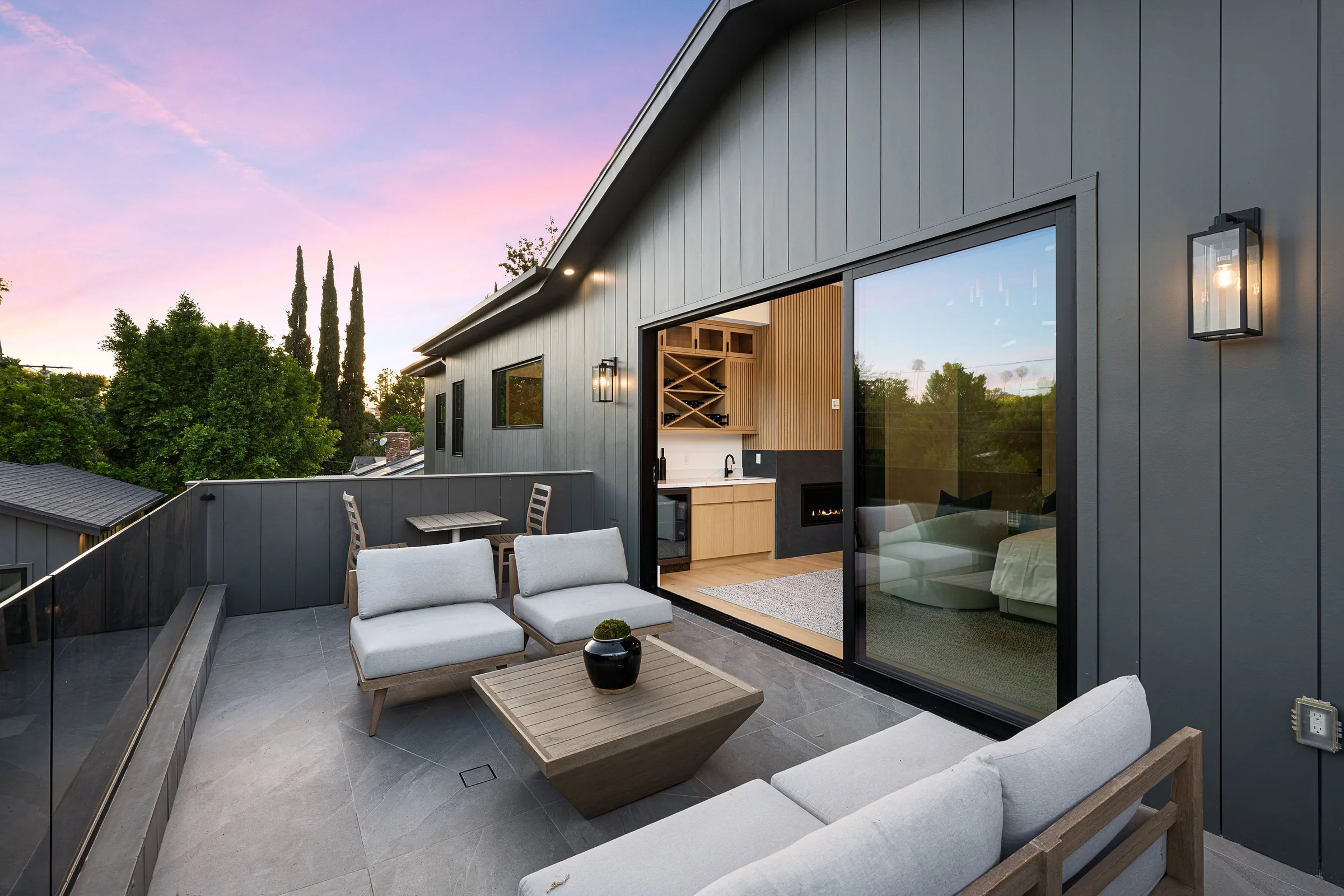 Room with a tall black-framed glass door opening to a garden